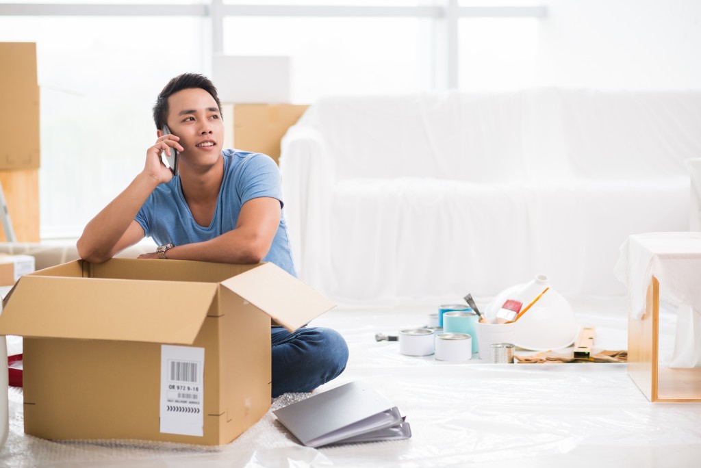 Man calling while unpacking to his new place