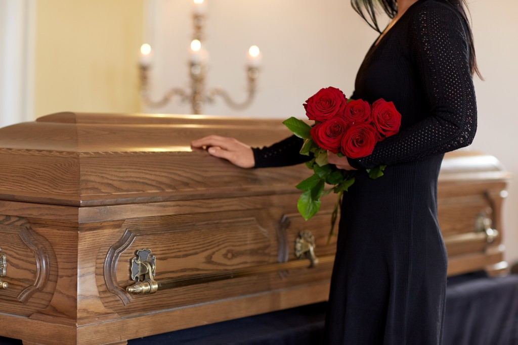 casket and mourning lady