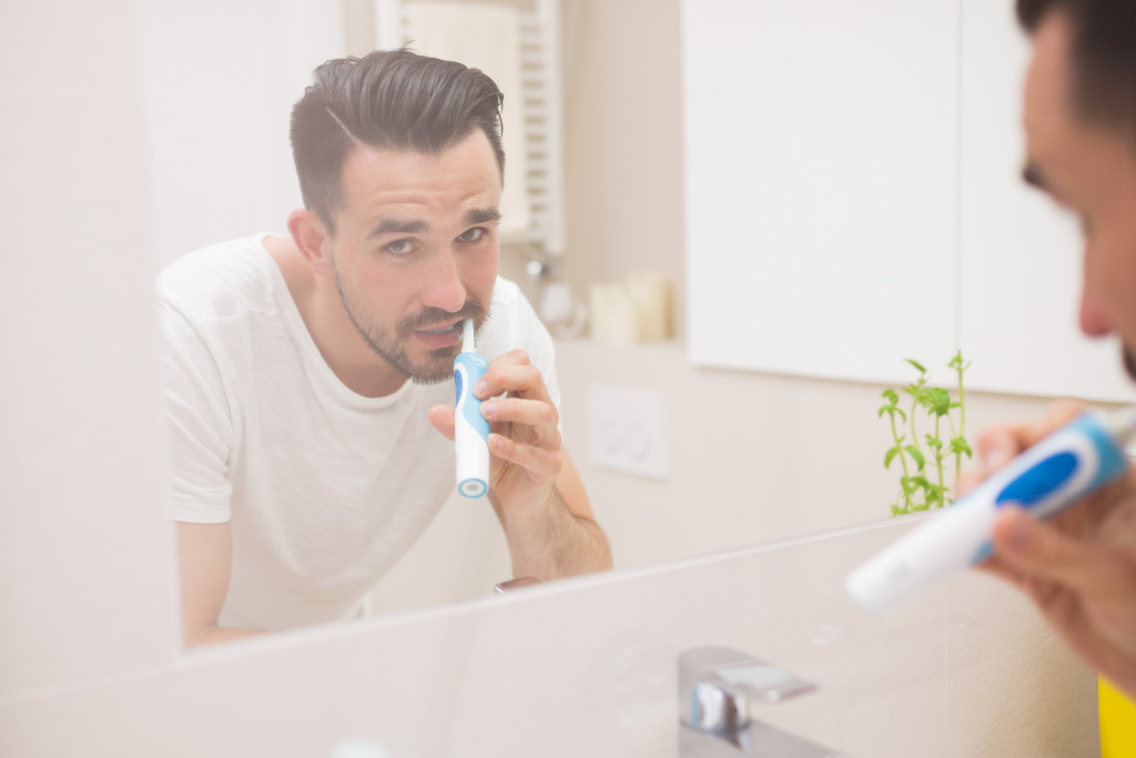 man brushing teeth