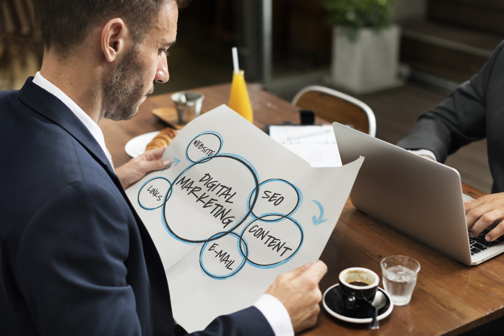 a businessman holding a draft for digital marketing