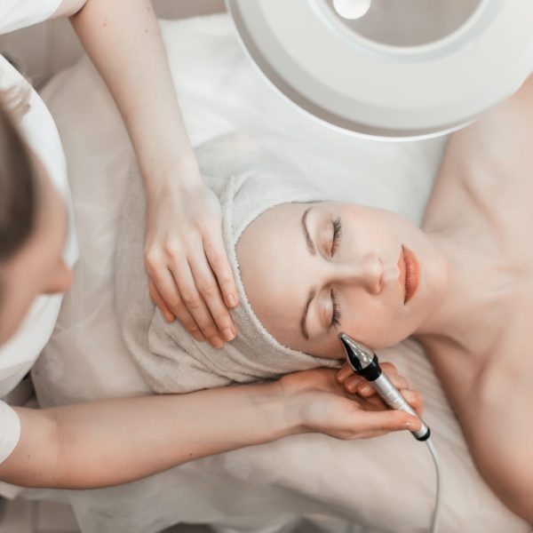 female lying in bed for facial beauty treatment