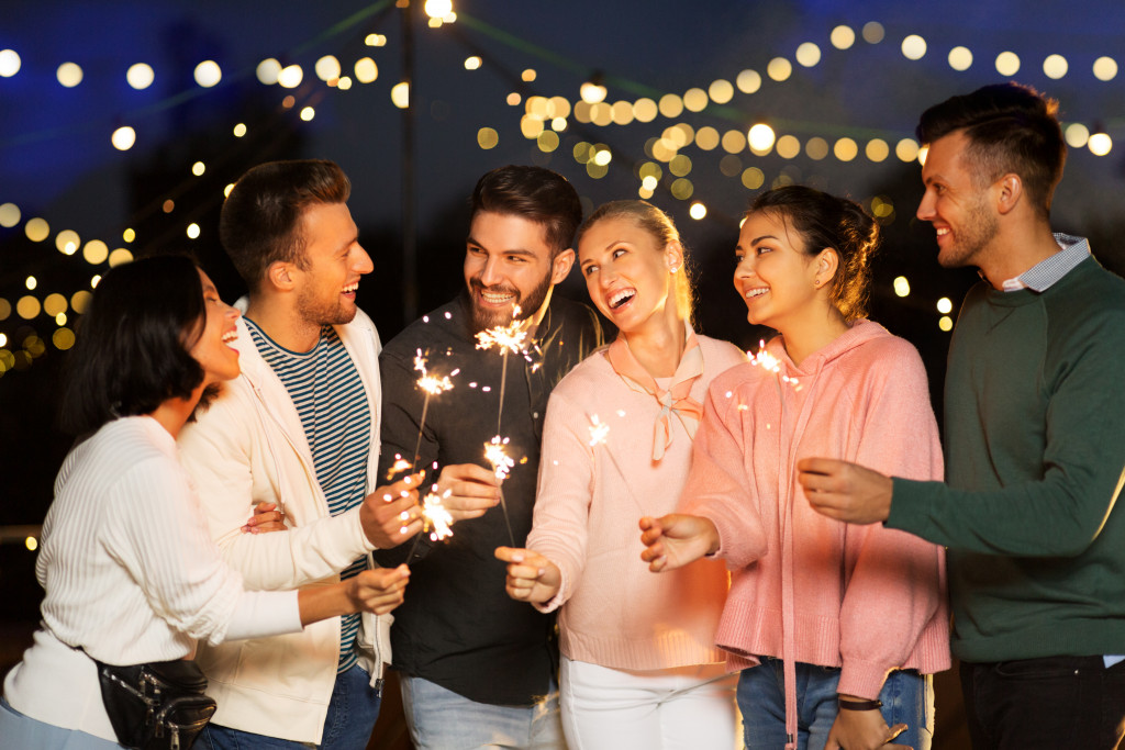 Group of friends partying on the rooftop of a building.