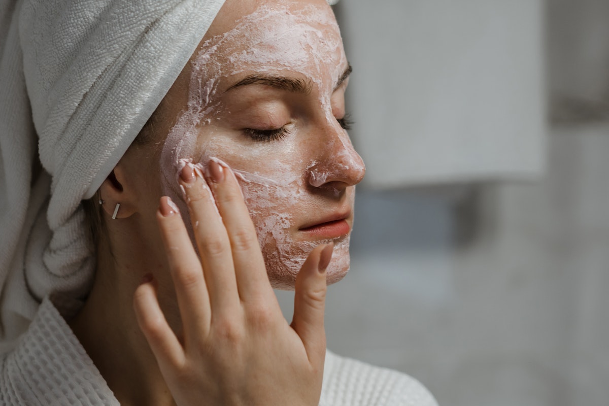 woman exfoliating her face