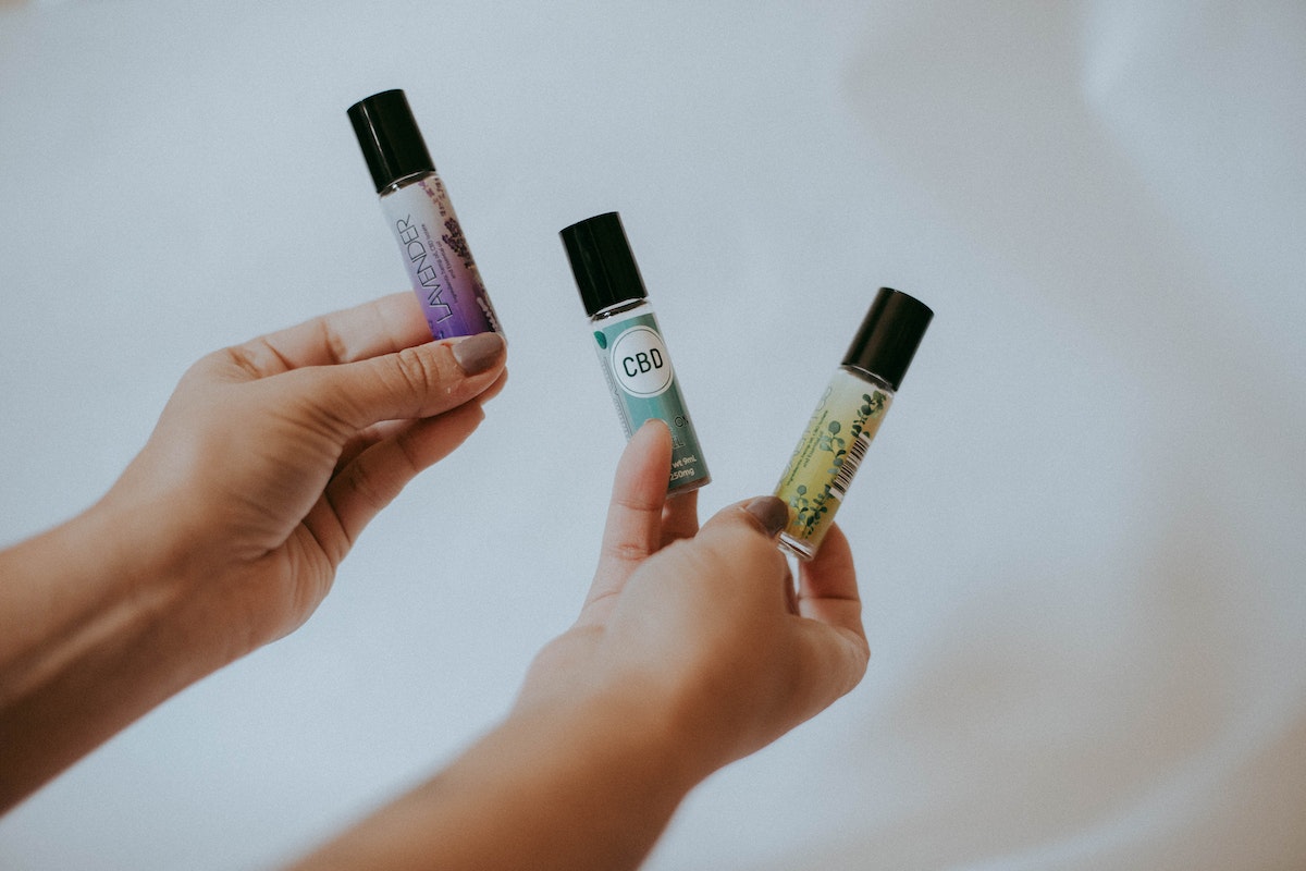 a person holding essential oils