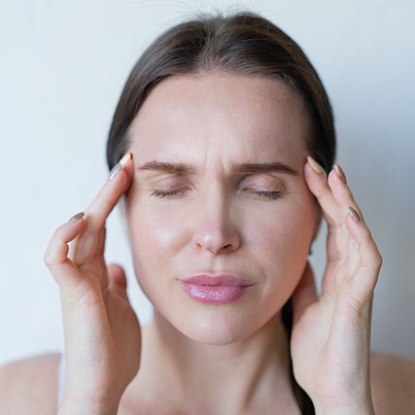woman feeling a strong head pain