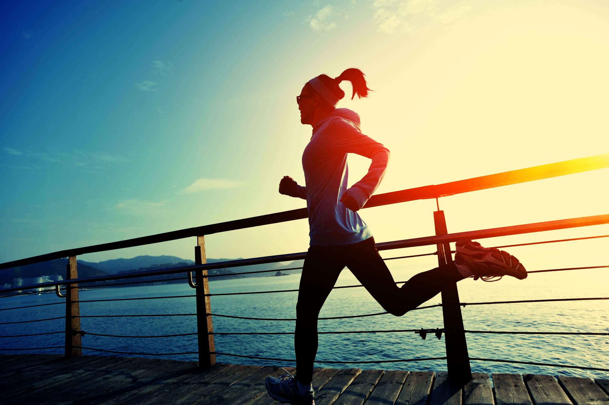 woman running on a boardwalk