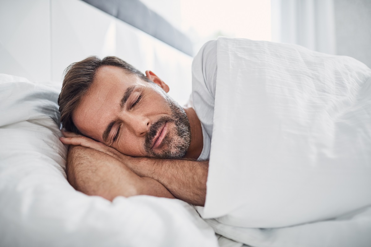 a man sleeping on his bed