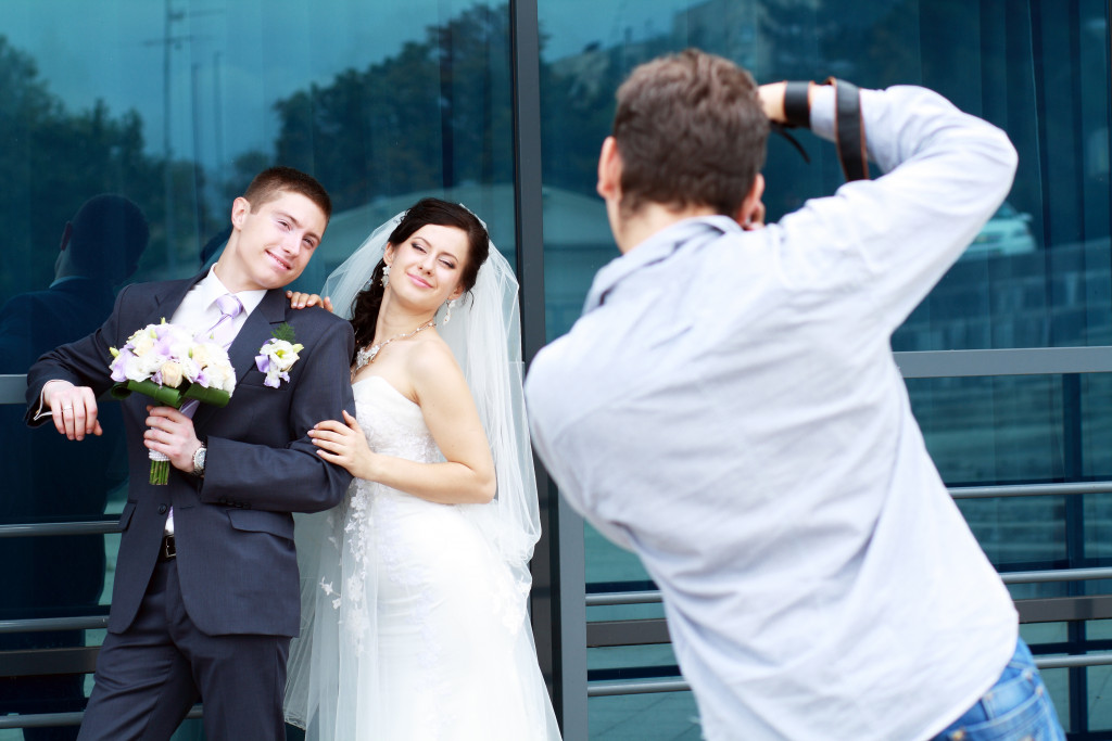 A photographer taking pictures of a newlywed