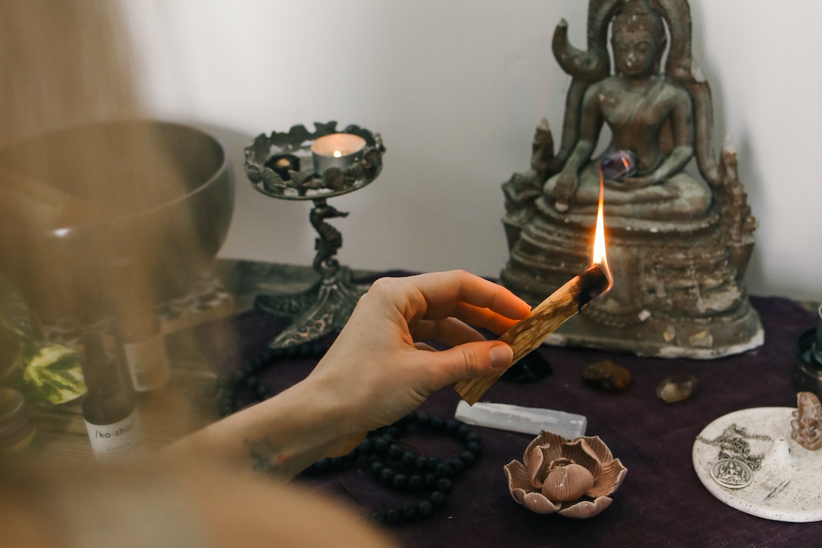 Person Holding a Burning Sage