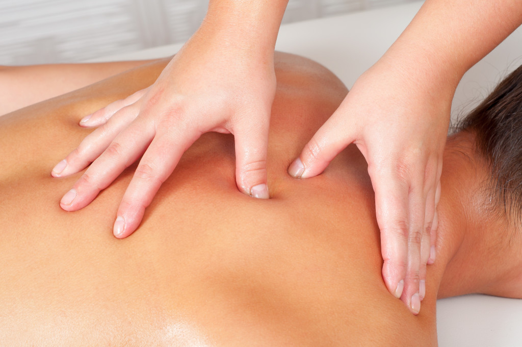 A person getting a back massage in a spa