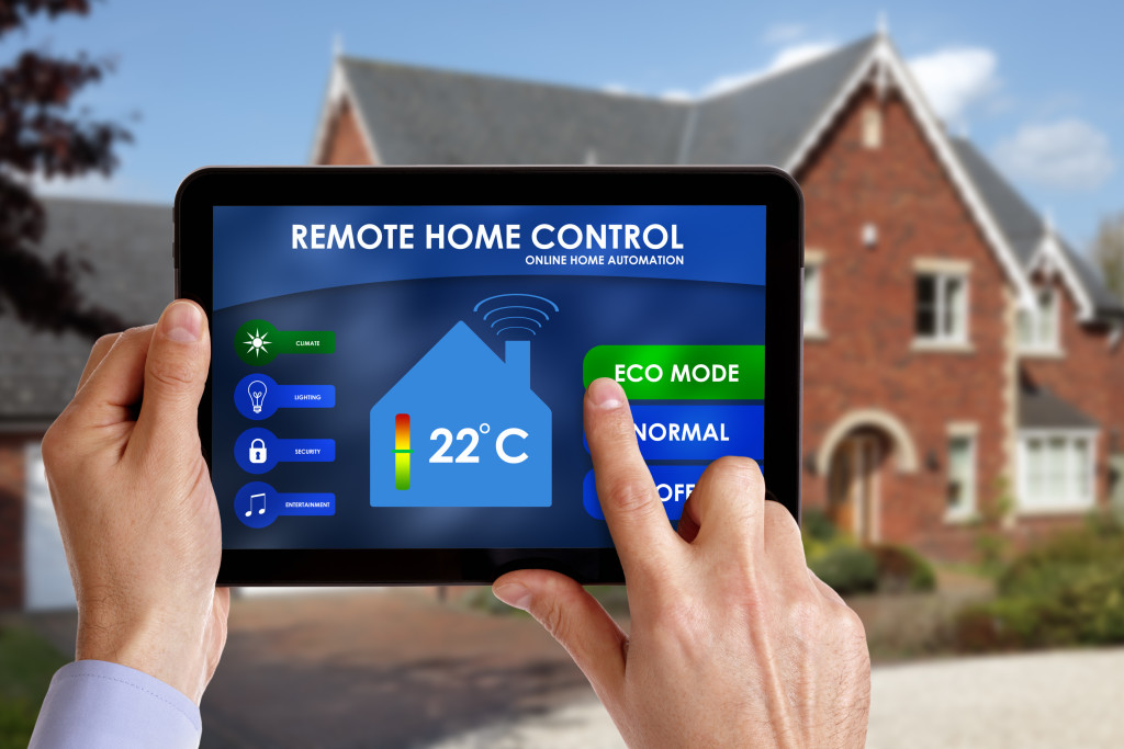 man controlling home with tablet across the street