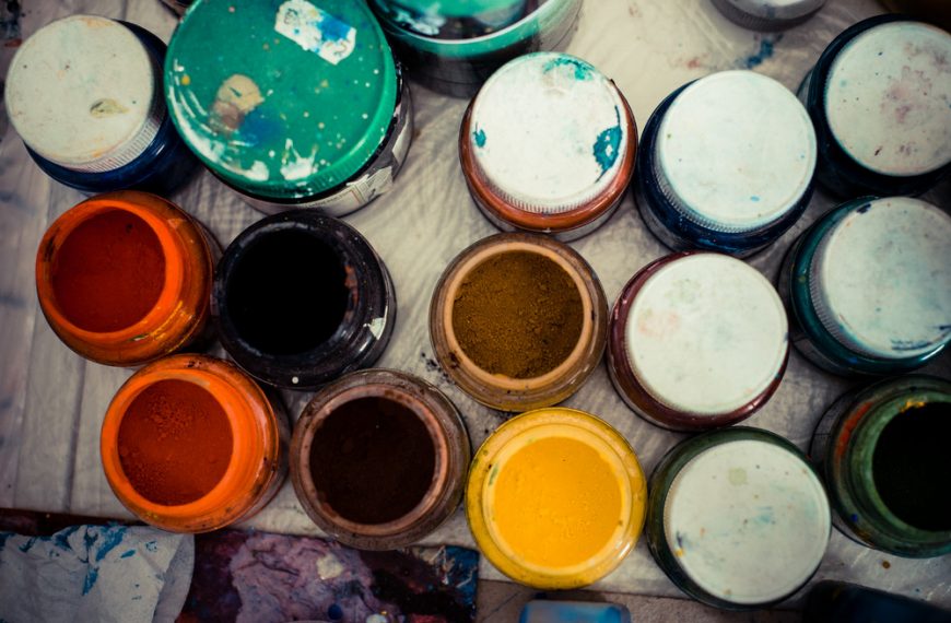 colored jars of powder paint in a painter studio